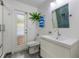 Bright bathroom features a glass door to the outside, a toilet, and a modern sink vanity at 7921 Sebago Ct, Orlando, FL 32835