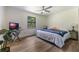 Bedroom with natural light, wood floors, and a dedicated workspace with a glass desk at 7921 Sebago Ct, Orlando, FL 32835