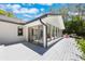 Exterior view showcasing an expansive deck, modern addition with large windows, and serene outdoor space at 7921 Sebago Ct, Orlando, FL 32835
