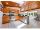 Bright kitchen features wood ceilings, stainless steel appliances, tile flooring, and granite countertops at 7921 Sebago Ct, Orlando, FL 32835