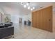 Spacious living room with tile floors, custom wood wall, and modern lighting, perfect for relaxation and entertaining at 7921 Sebago Ct, Orlando, FL 32835