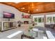 Charming living room with brick fireplace, wood ceilings, and plenty of natural light, perfect for Gathering gatherings at 7921 Sebago Ct, Orlando, FL 32835