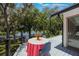 Charming outdoor dining area on a wooden deck, overlooking a peaceful lake surrounded by trees at 7921 Sebago Ct, Orlando, FL 32835