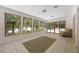 Bright sunroom featuring large windows with scenic views, tile floors, and elegant light fixtures at 7921 Sebago Ct, Orlando, FL 32835