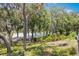 Waterfront view surrounded by lush greenery, featuring a scenic road and glimpses of serene lake at 7921 Sebago Ct, Orlando, FL 32835