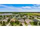 An aerial view of a residential area, highlighting the homes, green spaces, and a lake at 9413 Ivywood St, Clermont, FL 34711