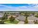 Aerial shot of a well-maintained house with a three-car garage and manicured lawn at 9413 Ivywood St, Clermont, FL 34711