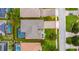 Aerial view of house with a swimming pool enclosed in a screen, manicured lawn, and brick driveway at 9413 Ivywood St, Clermont, FL 34711