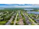 Residential neighborhood with a mix of houses, mature trees, and green lawns, situated near a lake at 9413 Ivywood St, Clermont, FL 34711