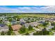 Neighborhood with a variety of single-Gathering homes, green lawns, and mature trees at 9413 Ivywood St, Clermont, FL 34711
