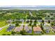 An aerial view shows a lakefront community with mature landscaping and various home styles at 9413 Ivywood St, Clermont, FL 34711