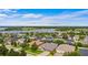 A neighborhood with well-maintained lawns and landscaping, alongside a scenic lake at 9413 Ivywood St, Clermont, FL 34711