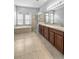 Large bathroom with double vanity, soaking tub, and a separate glass enclosed shower at 9413 Ivywood St, Clermont, FL 34711