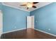 Bedroom features a ceiling fan, wood floors, and a neutral color scheme at 9413 Ivywood St, Clermont, FL 34711