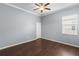 Bedroom features wood floors, ceiling fan, and a bright window at 9413 Ivywood St, Clermont, FL 34711