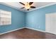 Bedroom features a ceiling fan, wood floors, and a bright window at 9413 Ivywood St, Clermont, FL 34711