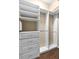 Large walk-in closet with custom shelving, drawers, and rods for organizing your wardrobe at 9413 Ivywood St, Clermont, FL 34711