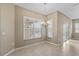 Cozy dining area with chandelier lighting and views of the pool area through the windows at 9413 Ivywood St, Clermont, FL 34711