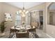Cozy dining area featuring a round table with seating for four, chandelier, and a sunny window at 9413 Ivywood St, Clermont, FL 34711