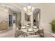 Cozy dining area featuring a round table with seating for four, chandelier, and arched doorways at 9413 Ivywood St, Clermont, FL 34711