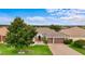 Well-maintained home with a three-car garage, lush green lawn, and mature landscaping at 9413 Ivywood St, Clermont, FL 34711