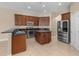 The kitchen has stainless appliances, granite counters, ample cabinets and an island at 9413 Ivywood St, Clermont, FL 34711