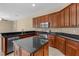 Gourmet kitchen has an island, stainless steel appliances, and granite countertops at 9413 Ivywood St, Clermont, FL 34711