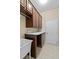 Laundry room with wood cabinets, countertop, sink, and tile flooring at 9413 Ivywood St, Clermont, FL 34711