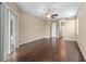 Spacious living room features a ceiling fan, sliding glass doors, and sleek wood flooring at 9413 Ivywood St, Clermont, FL 34711