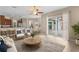 Open-concept living room showcasing stylish furnishings, tile floors, and sliding glass doors to the backyard at 9413 Ivywood St, Clermont, FL 34711