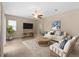 Comfortable living room with neutral tones, ceiling fan, tile flooring, and plenty of natural light at 9413 Ivywood St, Clermont, FL 34711