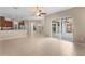 Open-concept living space with tile floors, large sliding glass doors, and direct access to kitchen at 9413 Ivywood St, Clermont, FL 34711