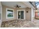 Screened patio with brick pavers, ceiling fan, and sliding glass doors to the living area at 9413 Ivywood St, Clermont, FL 34711