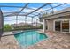 Screened in pool and spa with brick paver patio, covered lanai, and fountain at 9413 Ivywood St, Clermont, FL 34711