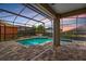 Enjoy a screened-in pool with a spa, perfect for relaxation with brick pavers, and beautiful sunset views at 9413 Ivywood St, Clermont, FL 34711
