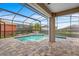 Screened in pool and spa with brick paver patio, covered lanai, and fountain at 9413 Ivywood St, Clermont, FL 34711