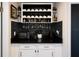 Stylish bar area features a wine rack, black backsplash, and cabinets for storage and serving at 999 W Juniata St, Clermont, FL 34711