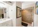 Clean bathroom featuring a large vanity, frameless mirror, and tiled walk-in shower at 999 W Juniata St, Clermont, FL 34711