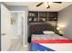Comfortable bedroom with built-in shelving, a patterned blanket, and neutral color palette at 999 W Juniata St, Clermont, FL 34711