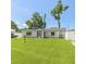 Charming single-story home featuring a manicured lawn, white fence, and inviting entrance at 999 W Juniata St, Clermont, FL 34711