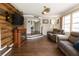 Cozy living room showcasing wood paneling, an electric fireplace, and comfortable seating at 999 W Juniata St, Clermont, FL 34711