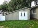 Backyard shed with double doors provides extra storage space; in need of a bit of TLC at 999 W Juniata St, Clermont, FL 34711