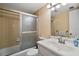 Bathroom with a shower-tub combination and a single sink vanity with light fixture and mirror at 101 N Grandview St # 103, Mount Dora, FL 32757