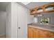 Kitchen area with wooden cabinets and countertop next to doorway leading to the living room at 101 N Grandview St # 103, Mount Dora, FL 32757