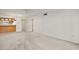 View of living room, with neutral carpet, half wall to kitchen, and neutral color scheme throughout at 101 N Grandview St # 103, Mount Dora, FL 32757