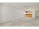Carpeted living room featuring a half wall to the kitchen and neutral wall colors, creating an open feel at 101 N Grandview St # 103, Mount Dora, FL 32757