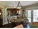 A beautiful dining area with a set table for meals, complemented by modern lighting fixtures at 1041 Reidville Rd, The Villages, FL 32162