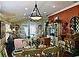 A quaint dining room space lit by a modern chandelier fixture at 1041 Reidville Rd, The Villages, FL 32162