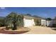 Charming single-story home with a well-maintained lawn, palm tree, and attached garage at 1041 Reidville Rd, The Villages, FL 32162