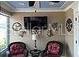 Comfortable living room includes ceiling fan, TV and accent furniture at 1041 Reidville Rd, The Villages, FL 32162